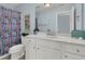 Well-lit bathroom with a white vanity, framed mirror, and a colorful shower curtain at 1325 Whisker Pole Ln, Mount Pleasant, SC 29466