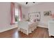 Charming pink bedroom with natural light, a comfortable bed, and delightful decor for a cozy atmosphere at 1325 Whisker Pole Ln, Mount Pleasant, SC 29466