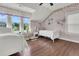 Charming bedroom with twin beds, patterned accent wall, and bright natural light from large windows at 1325 Whisker Pole Ln, Mount Pleasant, SC 29466
