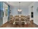 Elegant dining room with a wooden table, chandelier lighting, and serene blue walls at 1325 Whisker Pole Ln, Mount Pleasant, SC 29466