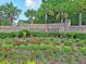 The Dunes West entrance features a brick sign surrounded by mature trees and a beautiful flower bed at 1325 Whisker Pole Ln, Mount Pleasant, SC 29466