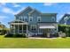 Beautiful backyard featuring a screened porch, patio, and outdoor kitchen at 1325 Whisker Pole Ln, Mount Pleasant, SC 29466
