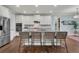 Bright kitchen features a granite island with seating, stainless steel appliances, and white cabinetry at 1325 Whisker Pole Ln, Mount Pleasant, SC 29466