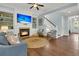Cozy living room with a fireplace, built-in shelves, and hardwood floors at 1325 Whisker Pole Ln, Mount Pleasant, SC 29466