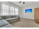 Bright living room with a large sectional sofa, sheer curtains, and a flat-screen TV at 1325 Whisker Pole Ln, Mount Pleasant, SC 29466