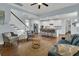 Open concept living room leading to the kitchen, with hardwood floors and lots of natural light at 1325 Whisker Pole Ln, Mount Pleasant, SC 29466