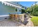 Outdoor kitchen featuring a built-in grill, brick patio, bar seating, and striped awning at 1325 Whisker Pole Ln, Mount Pleasant, SC 29466