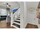 Staircase with dark wood steps and white risers flows into the living area with a comfortable blue sofa at 1325 Whisker Pole Ln, Mount Pleasant, SC 29466