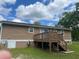 View of back exterior with small deck and access to the basement at 136 Gailmoor Dr, Ladson, SC 29456
