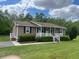 Charming single-story home with well-maintained lawn and mature landscaping at 136 Gailmoor Dr, Ladson, SC 29456