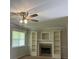 Bright living room with fireplace, built-in shelving and a ceiling fan at 136 Gailmoor Dr, Ladson, SC 29456