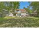 Lush backyard with a spacious lawn, a stone patio, and plenty of room for outdoor activities at 141 Bridgecreek Dr, Goose Creek, SC 29445
