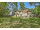 Expansive backyard with lush green grass, mature trees, and a lovely patio area, perfect for outdoor living at 141 Bridgecreek Dr, Goose Creek, SC 29445