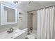 Bathroom with white shower curtain, a tiled shower and a nice mirror above the sink at 141 Bridgecreek Dr, Goose Creek, SC 29445