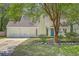 Charming home featuring an attached two-car garage, complemented by a blue front door and a well-maintained front yard at 141 Bridgecreek Dr, Goose Creek, SC 29445