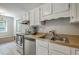 Well-maintained kitchen with white cabinetry, stainless steel appliances, and ample countertop space, ready for culinary adventures at 141 Bridgecreek Dr, Goose Creek, SC 29445