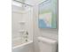 Close up of tub and toilet in bathroom showing a shower stall with a showerhead and neutral wall art at 1427 Clay Field Trl, Summerville, SC 29485