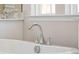 Close-up of bathtub fixtures in a bright bathroom, featuring elegant finishes at 1427 Clay Field Trl, Summerville, SC 29485
