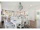 Bright, open dining area features a stylish chandelier and seamless flow to the living room and modern kitchen at 1427 Clay Field Trl, Summerville, SC 29485
