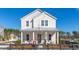 Charming two-story home featuring a welcoming front porch and manicured landscaping at 1427 Clay Field Trl, Summerville, SC 29485