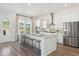 Spacious kitchen featuring a center island with seating, stainless steel appliances, and lots of natural light at 1427 Clay Field Trl, Summerville, SC 29485