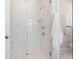 Modern bathroom shower features frameless glass door, clean white tile and a built-in bench at 1427 Clay Field Trl, Summerville, SC 29485