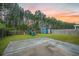 Backyard featuring a large patio, playground, shed, privacy fence, and mature trees at 145 Basket Grass Ln, Summerville, SC 29486