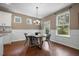 Dining area with wood table, modern chairs, natural light, and views of the backyard at 145 Basket Grass Ln, Summerville, SC 29486