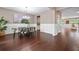 Elegant dining room featuring a modern chandelier, wainscoting, and rich hardwood floors at 145 Basket Grass Ln, Summerville, SC 29486