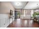 Inviting entryway featuring wood floors, elegant console table, and open door with a view of the landscaped front yard at 145 Basket Grass Ln, Summerville, SC 29486