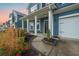 Close-up of a charming front porch adorned with potted plants and cozy seating at 145 Basket Grass Ln, Summerville, SC 29486