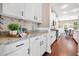 Bright kitchen boasting white cabinets, granite countertops, and stylish backsplash at 145 Basket Grass Ln, Summerville, SC 29486