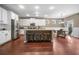 Spacious kitchen with white cabinetry, stainless appliances, an island with barstools, and adjacent dining area at 145 Basket Grass Ln, Summerville, SC 29486
