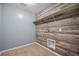 Laundry room featuring hookups and shelving; the back wall boasts a rustic wood panel at 145 Basket Grass Ln, Summerville, SC 29486