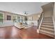 Inviting living room with neutral tones, large windows, wainscoting, and staircase to the upper level at 145 Basket Grass Ln, Summerville, SC 29486