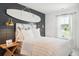 Stylish bedroom with wood accent wall and window views, creating a modern and comfortable retreat at 153 Threaded Fern St, Summerville, SC 29485