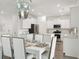 Elegant dining room with white table and chairs next to the kitchen at 153 Threaded Fern St, Summerville, SC 29485