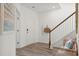 Bright entryway with hardwood floors, staircase, and a cozy bench at 153 Threaded Fern St, Summerville, SC 29485