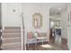 Welcoming entryway with staircase, decorative mirror, bench, and hardwood floors at 153 Threaded Fern St, Summerville, SC 29485