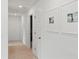 Bright hallway featuring neutral walls, carpet and framed artwork, providing a clean and modern look at 153 Threaded Fern St, Summerville, SC 29485