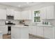 Modern kitchen featuring white cabinets, stainless steel appliances, and a center island at 153 Threaded Fern St, Summerville, SC 29485