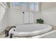 Relaxing bathroom with an oval soaking tub and a plant accent at 1531 Capel St, Mount Pleasant, SC 29466