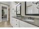 Bathroom showcasing double sinks, granite countertop, white cabinetry, and views into the walk-in closet at 1531 Capel St, Mount Pleasant, SC 29466