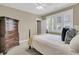 Bedroom featuring a four poster bed, light neutral walls, and a dresser at 1531 Capel St, Mount Pleasant, SC 29466