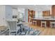 Dining area features modern table, striped chairs, and connects to a kitchen with an island at 1531 Capel St, Mount Pleasant, SC 29466