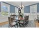 This bright dining room features wainscoting, stylish chandelier, and many windows with plantation shutters at 1531 Capel St, Mount Pleasant, SC 29466