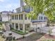 Multi-story home with a back porch, attached garages, manicured lawn, and charming outdoor space at 1531 Capel St, Mount Pleasant, SC 29466