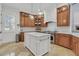 Bright kitchen featuring an island with white countertop, stainless steel appliances, and wooden cabinets at 1531 Capel St, Mount Pleasant, SC 29466