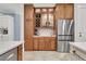 This kitchen features custom cabinetry, stainless steel refrigerator, and quartz countertops at 1531 Capel St, Mount Pleasant, SC 29466