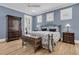 Comfortable bedroom with hardwood floors, a blue accent wall, and well-appointed furnishings at 1531 Capel St, Mount Pleasant, SC 29466